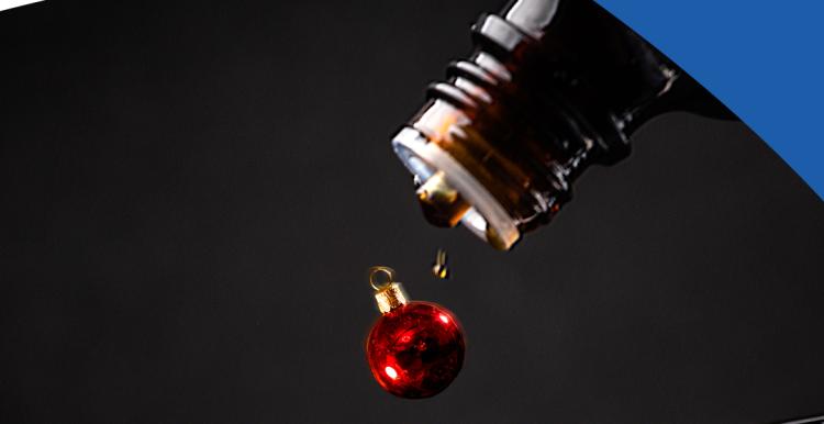 medicine and Christmas bauble being poured onto spoon