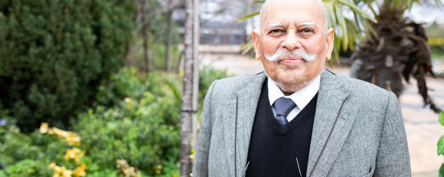 Elderly gentleman standing in a courtyard