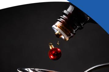 medicine and Christmas bauble being poured onto spoon