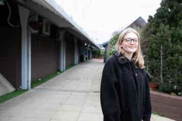 Young woman stood in a courtyard