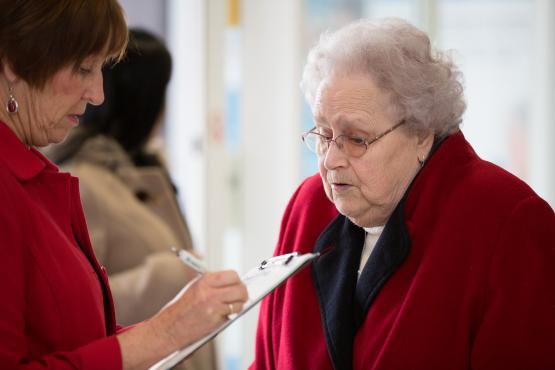 Elderly lady filling in survey