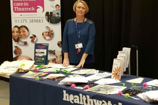 Healthwatch staff member talking to group of people