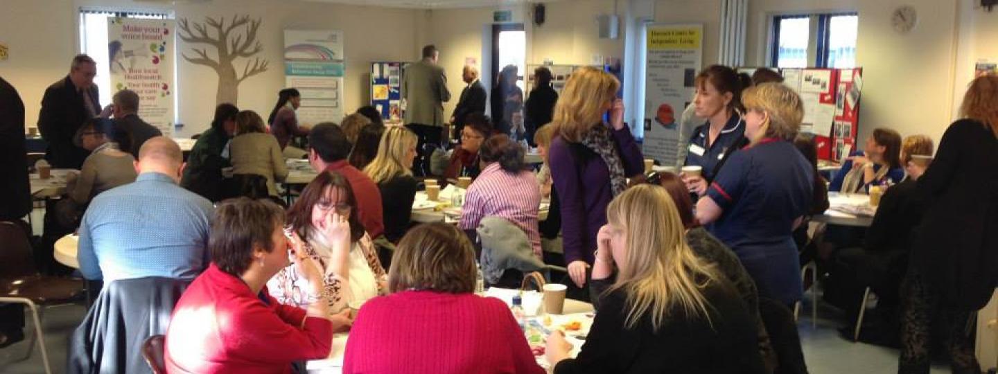 Four people standing at Healthwatch event